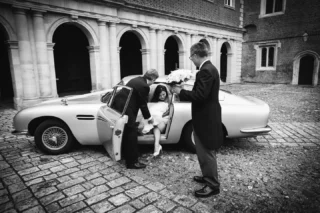 Proof that you CAN get a bride and her designer wedding dress into the back seat of the iconic Aston Martin 1965 DB5. 
Then you just walk to your wedding ceremony at equally iconic Eton College

I wanted to post this today as 15th February 1965 was the date I was born so those who do the maths will realise I celebrated a big milestone at the weekend!
Anyway back to that DB5!….
•
•
•
•
#astonmartindb5 #etoncollegewedding #artisticweddingphotography #ukweddingphotography #blackandwhiteweddingphotography #weddingshots #creativeweddingphotographer #weddingpost #londonweddingphotography #romanticweddings #weddingcouples #couplesphotos  #weddingshot #weddingspecialist #dreamweddingshots #weddingpicture #creativeweddingphotography #wedding_photography #naturalweddingphotography #weddingsupercars  #weddingphotographyinspiration #weddingdayphoto #luxuryweddingphotographer #fineartweddingphotography #ukweddingphotographer #weddingportraits #fineartweddingphotographer #weddingphotoshoot #weddingportrait#weddingphotographer